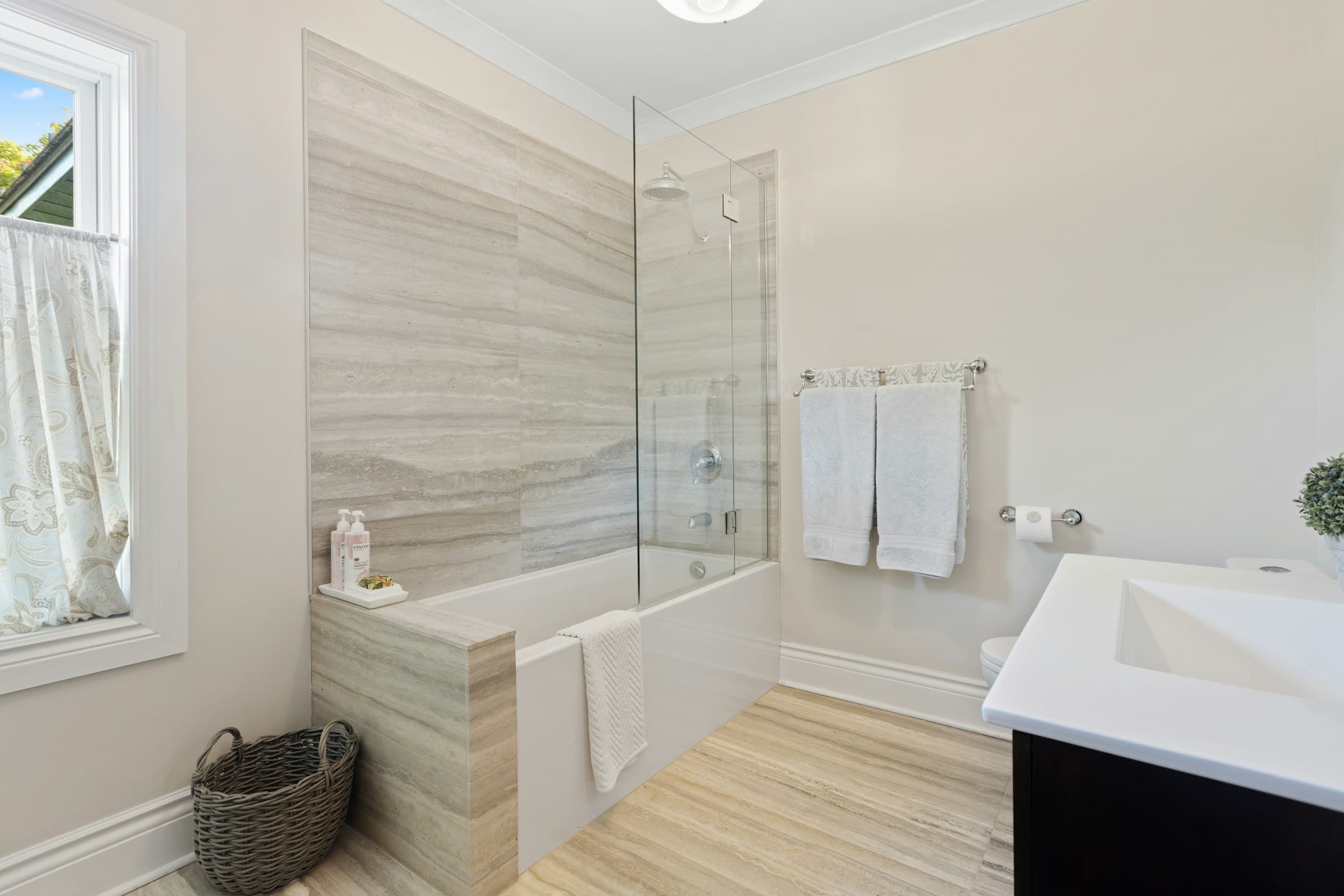 Bathroom with a bath, a glass shower screen and a basin (placeholder photo)