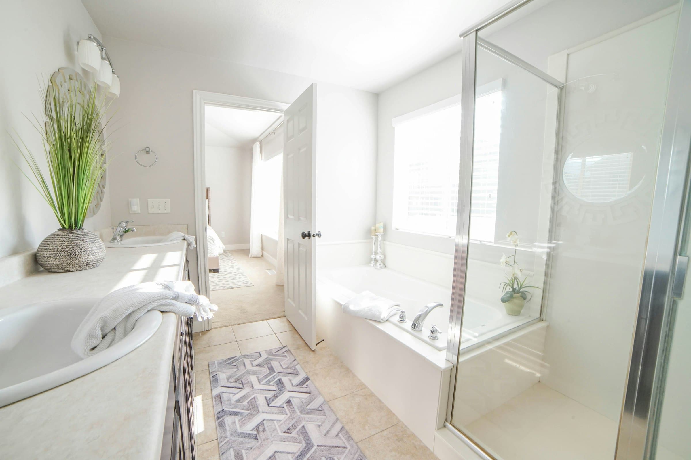 Bright bathroom with a bathtub and a glass shower (placeholder photo)