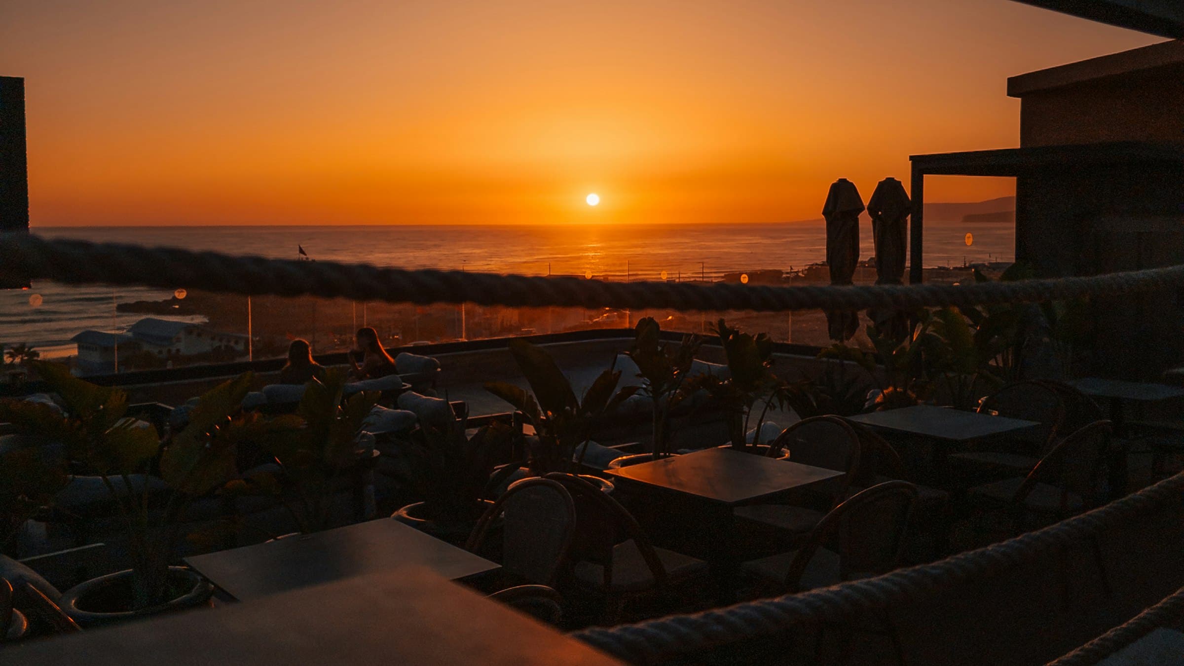 Rooftop terrace with tables at sunset over the sea (placeholder photo)